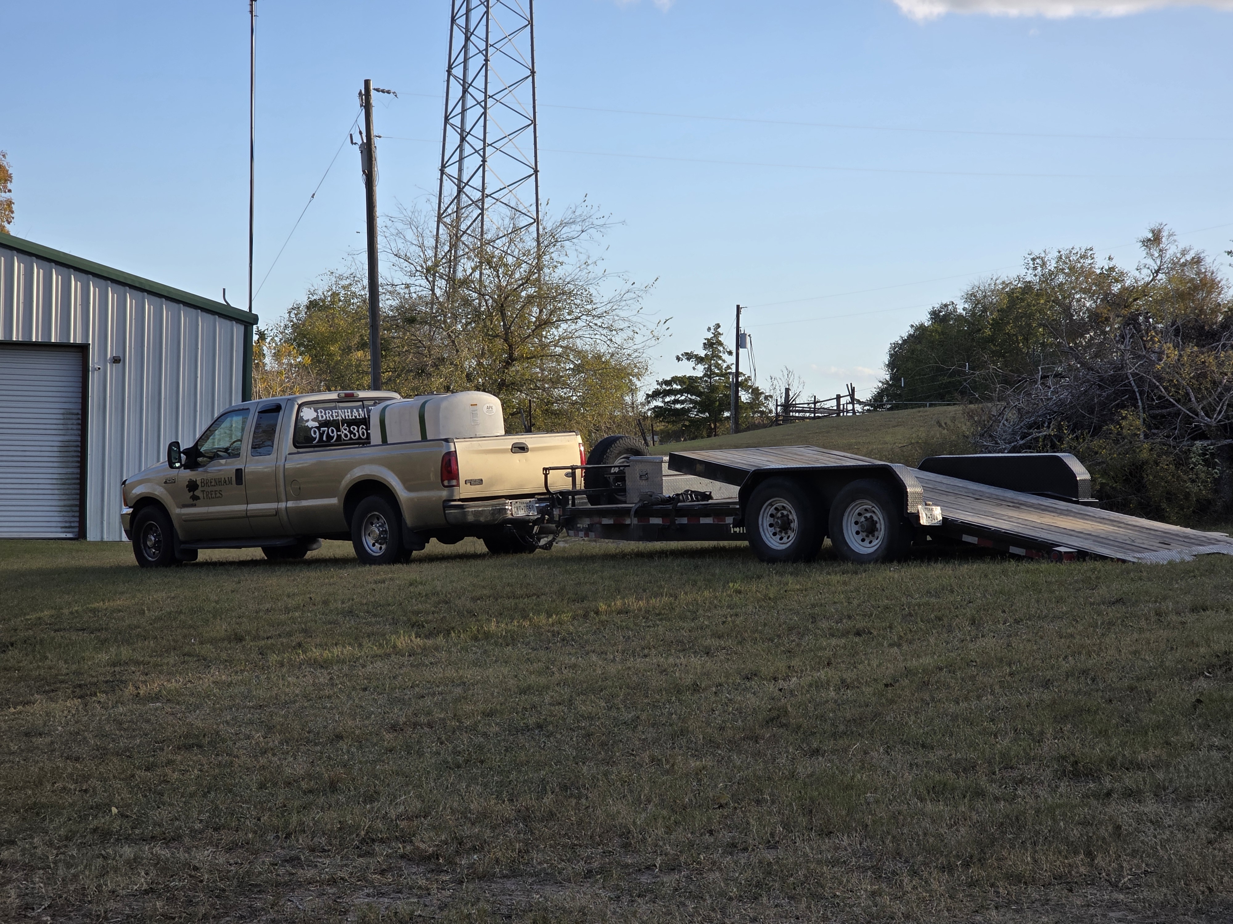 Brenham Trees truck and equipment trailer loaded for the day