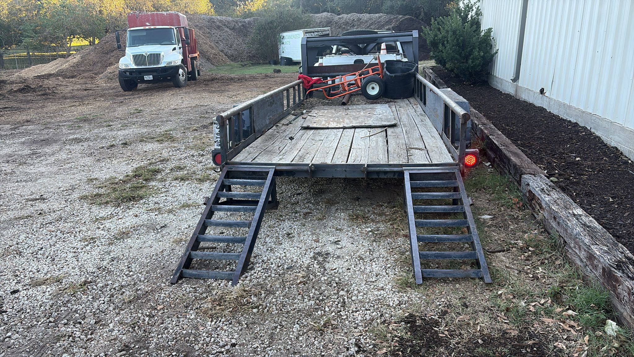Equipment trailer and trucks staged at the Brenham Trees yard